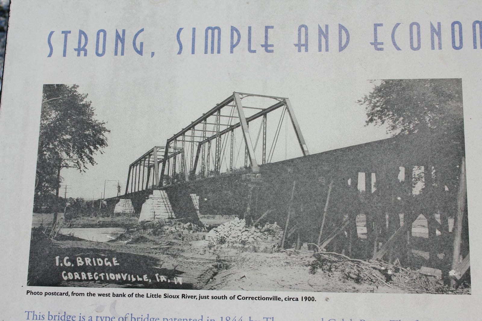 Historic photo of bridge, showing both truss spans intact